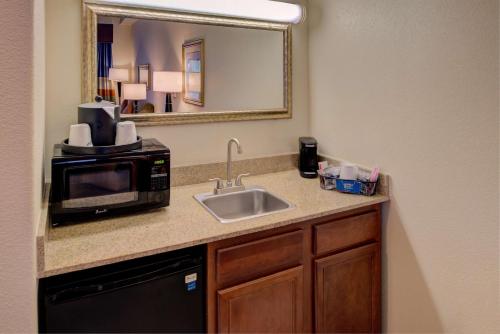a kitchen counter with a microwave and a sink at Hampton Inn & Suites Ontario in Ontario