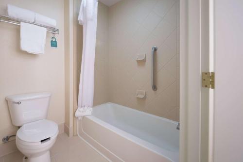 een badkamer met een toilet, een bad en een douche bij Homewood Suites by Hilton Ontario Rancho Cucamonga in Rancho Cucamonga