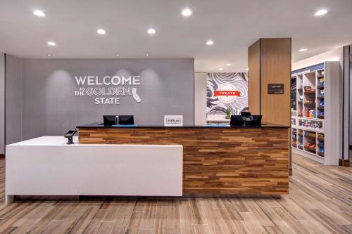 a lobby of a colgate store with a reception counter at Hampton Inn & Suites By Hilton Rancho Cucamonga in Rancho Cucamonga