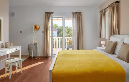 a bedroom with a yellow bed and a desk and a balcony at Villa 1 Mala Rudina in Rudina