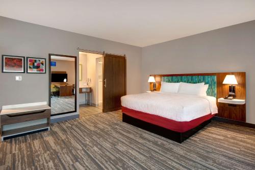 a hotel room with a bed and a flat screen tv at Hampton Inn & Suites By Hilton Rancho Cucamonga in Rancho Cucamonga