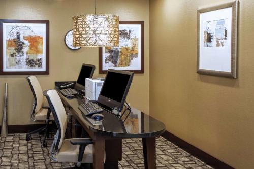 an office with a desk with two computers on it at Homewood Suites by Hilton Munster in Munster