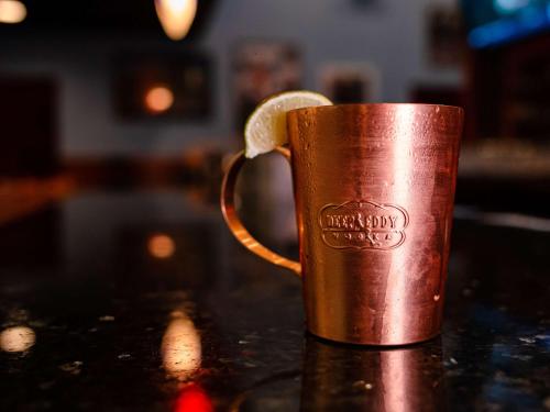 a copper coffee mug with a slice of lemon in it at DoubleTree by Hilton Norfolk Airport in Norfolk