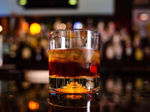 a glass of whiskey sitting on a table at DoubleTree by Hilton Norfolk Airport in Norfolk