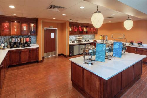 a large kitchen with a football helmet on a counter at Homewood Suites by Hilton Virginia Beach in Virginia Beach