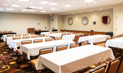 a dining room with white tables and chairs at Hampton Inn Gloucester in Gloucester