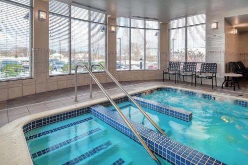 a pool with blue water in a hotel room at Hilton Garden Inn Devens Common in Devens