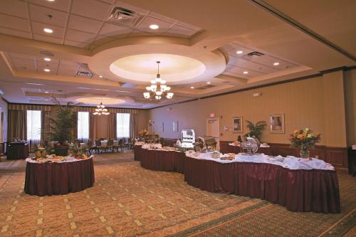 a banquet hall with tables in the middle of it at Hilton Garden Inn Devens Common in Devens