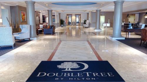 a lobby with agraduate sign in the middle of a building at Doubletree by Hilton, Leominster in Leominster