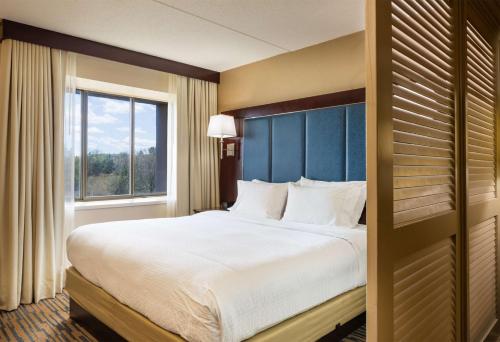 a hotel room with a large bed and a window at Doubletree by Hilton, Leominster in Leominster
