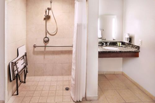 a bathroom with a shower and a sink at Hilton Grand Vacations Club Tuscany Village Orlando in Orlando