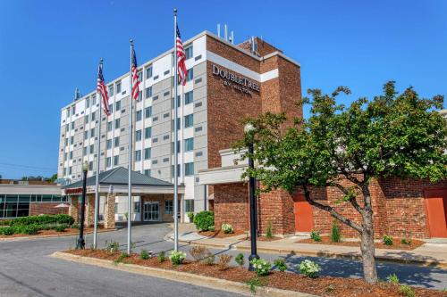 a hotel with two american flags on top of it at DoubleTree by Hilton Neenah in Neenah