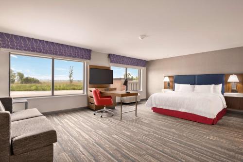 a hotel room with a bed and a desk at Hampton Inn & Suites Norman-Conference Center Area, Ok in Norman