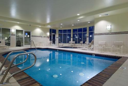 a pool in a hotel with chairs at Hilton Garden Inn Seattle North/Everett in Mukilteo