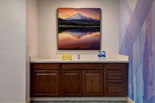 a bathroom with a picture of a mountain on the wall at Hilton Garden Inn Portland/Beaverton in Beaverton