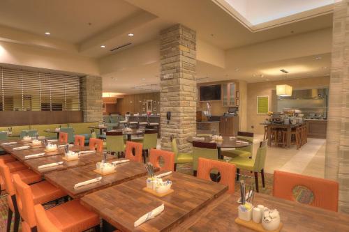 a dining room with wooden tables and chairs at Hilton Garden Inn Pigeon Forge in Pigeon Forge
