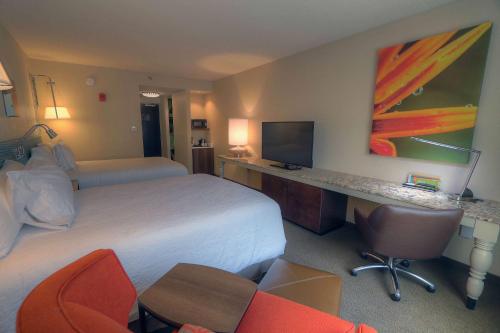 a hotel room with a bed and a desk at Hilton Garden Inn Pigeon Forge in Pigeon Forge