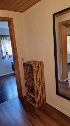 a room with a wooden cabinet next to a mirror at Ferienwohnung Bergfreunde inkl Chiemgaukarte in Bergen
