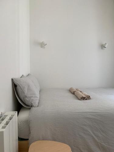 a white bedroom with a bed with a pillow at Nº7 Sacadura Cabral in Guarda