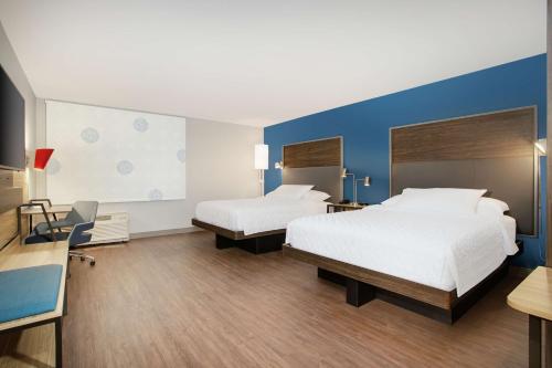 Habitación de hotel con 2 camas y pared azul en Tru By Hilton Audubon Valley Forge, en Audubon