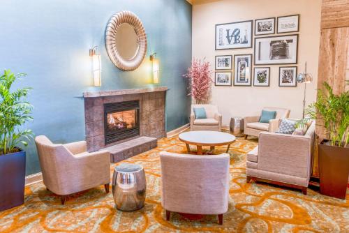 a lobby with a fireplace and chairs and a table at DoubleTree by Hilton Philadelphia Airport in Philadelphia