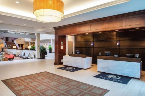 a lobby with a reception desk in a hotel at DoubleTree Suites by Hilton Hotel Philadelphia West in Plymouth Meeting