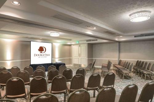 a conference room with chairs and a screen at DoubleTree by Hilton Philadelphia Airport in Philadelphia