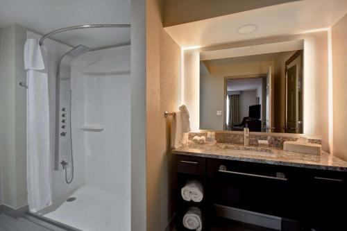 a bathroom with a sink and a shower and a mirror at Homewood Suites by Hilton Philadelphia-Great Valley in Malvern