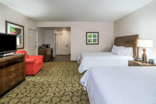 a hotel room with two beds and a flat screen tv at Hilton Garden Inn Valley Forge/Oaks in Oaks