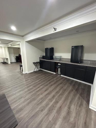 an empty room with two flat screens on a counter at Clarion Pointe - Greensboro Coliseum Area in Greensboro