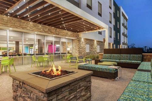 a hotel patio with a fire pit and tables and chairs at Home2 Suites By Hilton Ridley Park Philadelphia Airport So in Ridley Park