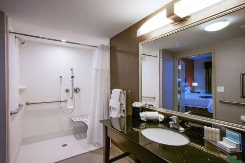 a bathroom with a sink and a shower and a mirror at Hampton Inn & Suites Philadelphia/Bensalem in Bensalem