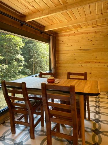 a wooden table and chairs in a room with a window at Ayder Villa Gencal King in Ayder Yaylasi