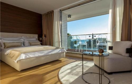 a bedroom with a bed and a view of the ocean at Villa Magnolia in Petrcane