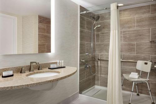 a bathroom with a sink and a shower at Embassy Suites by Hilton Philadelphia Valley Forge in Wayne