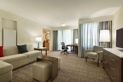 a large living room with a couch and a desk at Embassy Suites by Hilton Philadelphia Valley Forge in Wayne