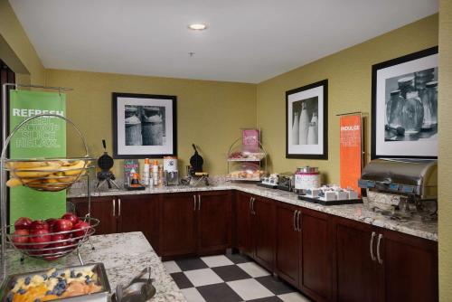 a kitchen with wooden cabinets and a counter with apples on it at Hampton Inn Phoenix/Anthem in Anthem