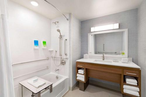 a bathroom with a sink and a shower with a mirror at Home2 Suites By Hilton Scottsdale Salt River in Scottsdale