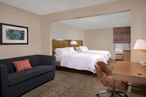 a hotel room with a bed and a couch at Hampton Inn Phoenix/Anthem in Anthem