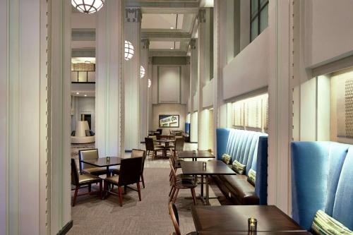 a dining room with tables and chairs and tablesearcher at Hilton Garden Inn Phoenix Downtown in Phoenix