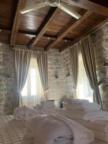 a room with a bunch of white beds in it at KAŽIN supreme in Kotor