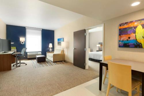 a hotel room with a bed and a desk at Home2 Suites By Hilton Glendale Westgate in Glendale