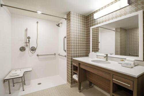 a bathroom with a sink and a mirror at Home2 Suites By Hilton Mesa Longbow, Az in Mesa