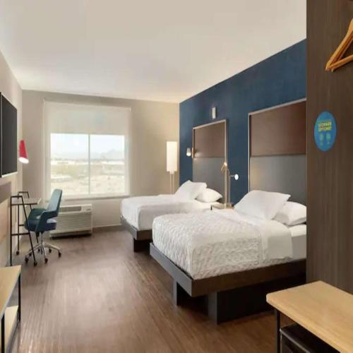 a hotel room with two beds and a desk at Tru By Hilton Scottsdale Salt River in Scottsdale