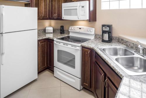 a kitchen with a white refrigerator and a sink at Hilton Vacation Club Scottsdale Links Resort in Scottsdale