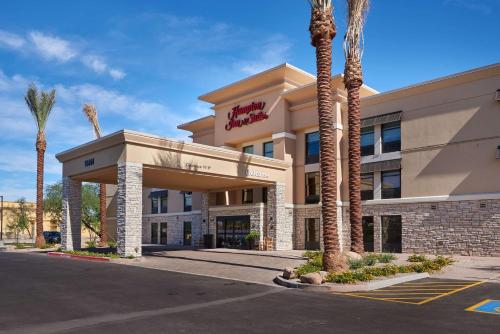 a hotel building with palm trees in front of it at Hampton Inn & Suites Scottsdale On Shea Blvd in Scottsdale