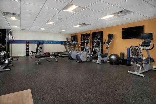a gym with several machines and a flat screen tv at Hampton Inn & Suites Scottsdale On Shea Blvd in Scottsdale