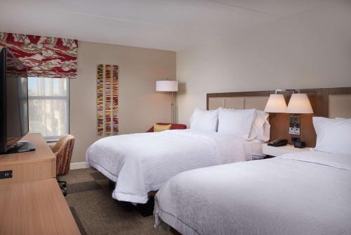 a hotel room with two beds and a flat screen tv at Hampton Inn & Suites Scottsdale On Shea Blvd in Scottsdale