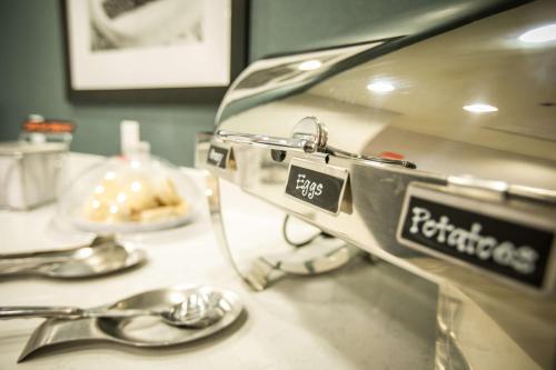 a kitchen counter with a plate of food and spoons at Hampton Inn & Suites Tempe/Phoenix Airport, Az in Tempe