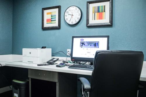 an office with a desk with a computer and a clock at Hampton Inn & Suites Tempe/Phoenix Airport, Az in Tempe